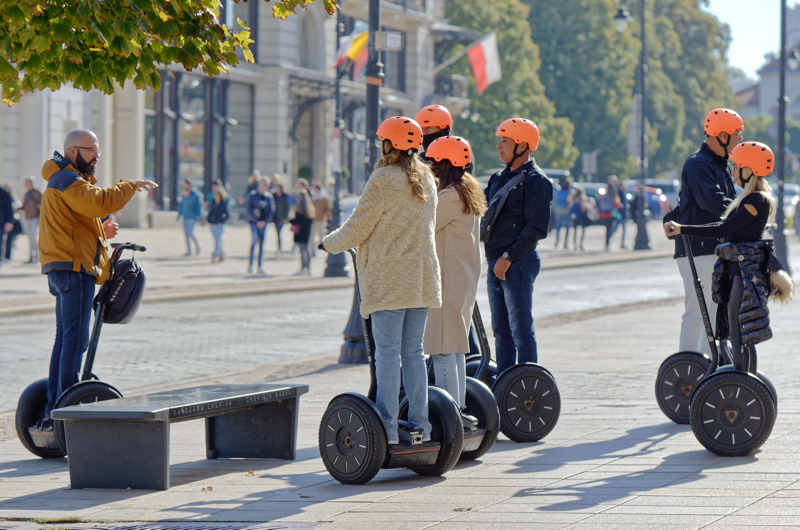 Group of tourists taking a guided Segway tour on a sunny day in Warsaw
